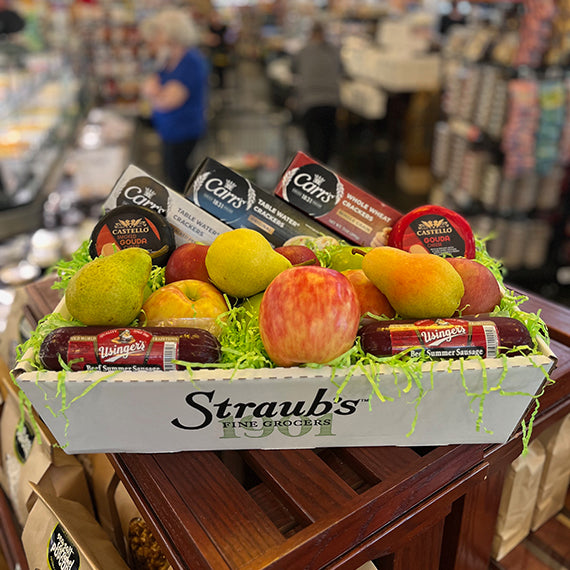 Fruit basket with deli meats in a grocery store setting