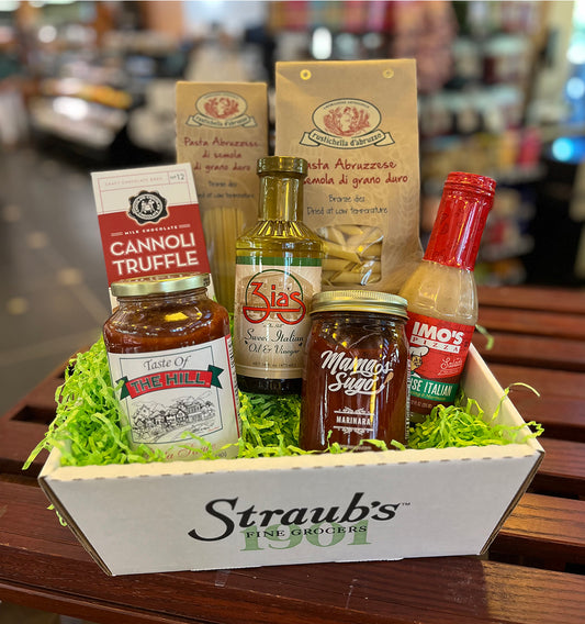 Assorted food items including bottles and jars in a box with 'Straub's' branding.