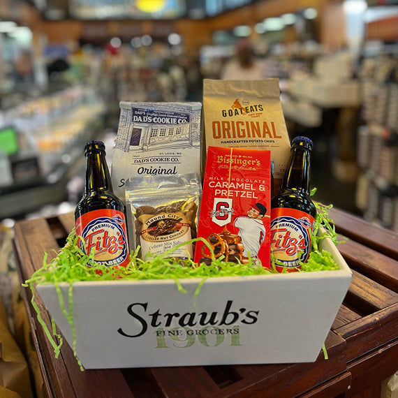 Gift basket with root beer and snacks on a wooden table in a store setting