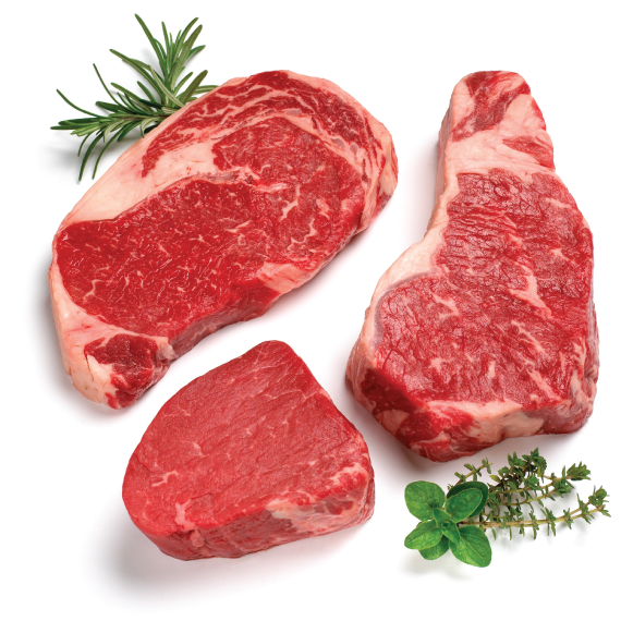 Three raw steak pieces with herbs on a white background