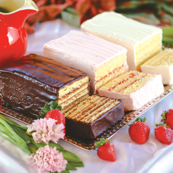 3 layered cakes next to strawberries.